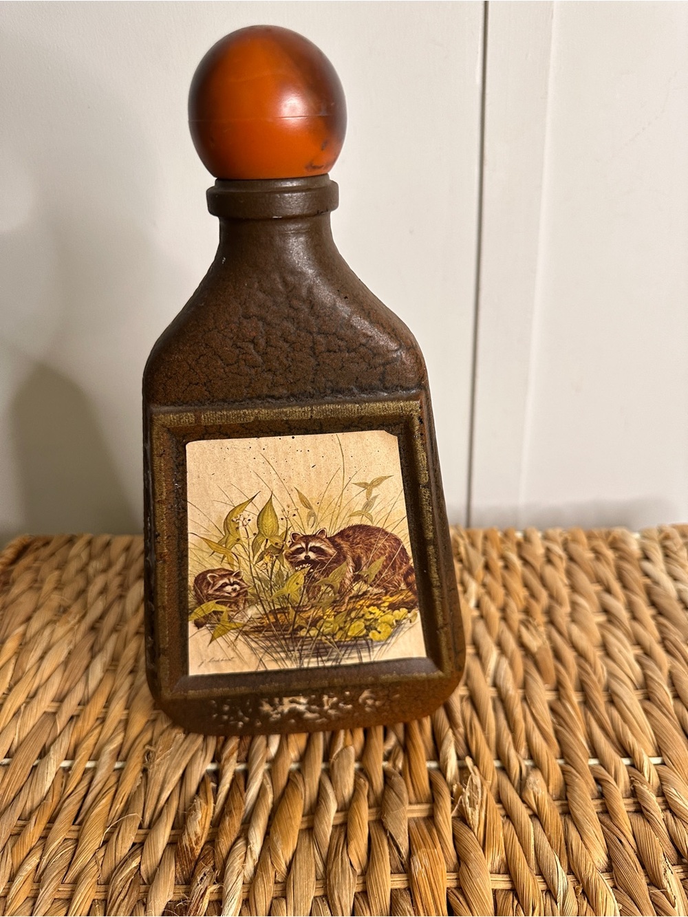 Vintage Jim Beam bottle with Orange Stopper and Raccoon Motif